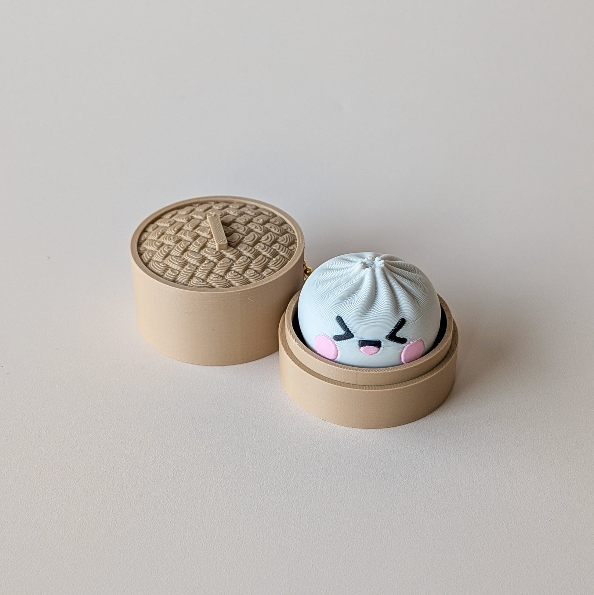 Close-up of Dumpling Clicker showing mystery face detail — sensory fidget toy by Elevated Expressions