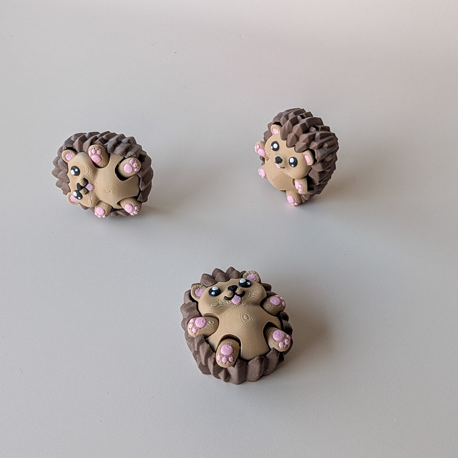 Hedgehog Clicker showing articulated arms in motion — clicky or silent switch fidget toy