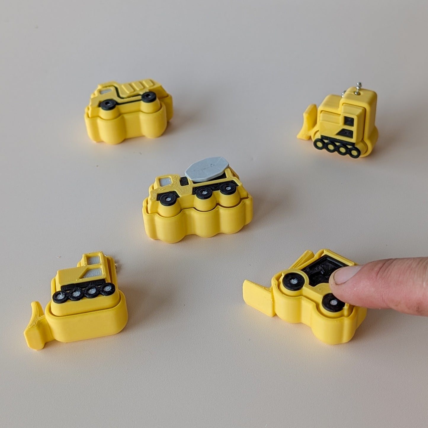 Construction Clicker fidget toys — cement truck, forklift, bulldozer and dump truck clicker designs by Elevated Expressions